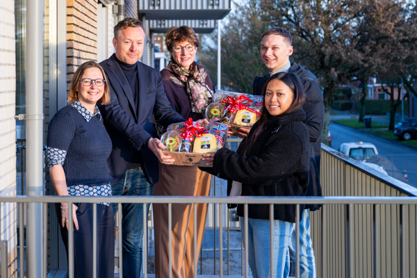 Bestuurders heten eerste bewoners welkom met een cadeautje bij de oplevering.